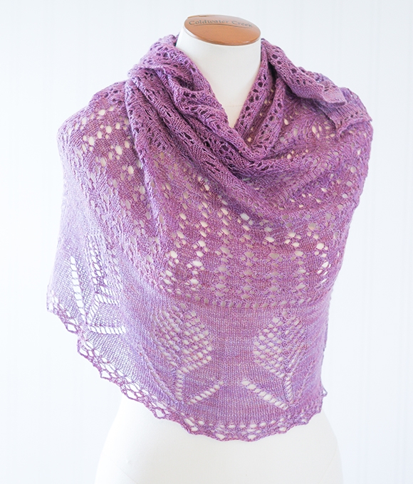 Evening Fields lace shawl knitting pattern featuring eyelets and flower motifs. Worked in CashSilk Lace weight yarn