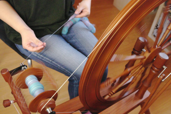Felicia Lo Wong spinning rolags on a Lendrum Saxony wheel